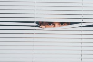suspicious-young-man-peeking-and-looking-at-camera-through-blinds-mistrust-concept-1124692168_726x484-300x200