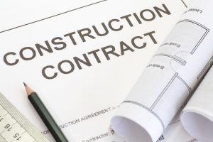 Close-up-construction-contract-with-pen-and-architectural-roll-528238925_725x483-300x200
